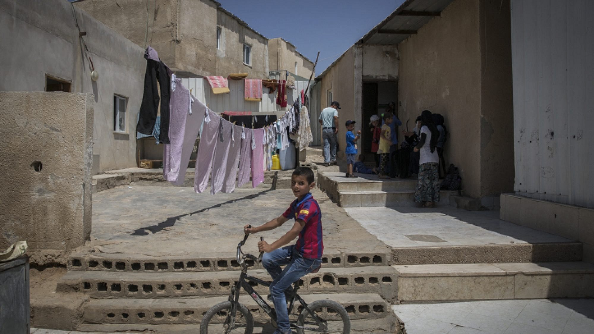 Bedouins seen outside their home in the  village of Umm al Hiran in the Negev Desert on Aug. 27, 2015. It is one of about 46 unrecognized Bedouin villages in Israel. Photo by Hadas Parush/Flash90.