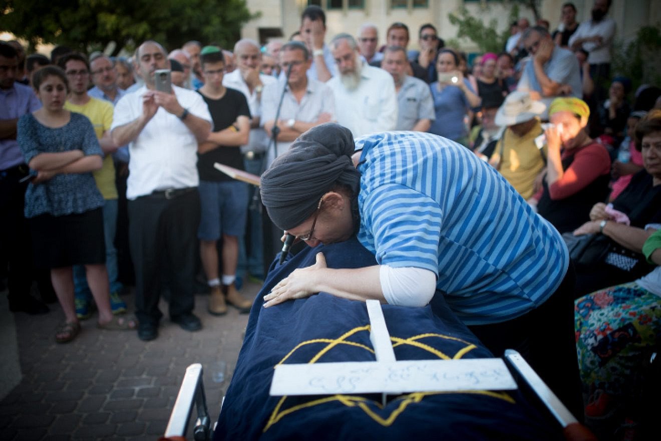 The mother of Hallel Yaffa Ariel and family members mourn over her body during her funeral ceremony in the Jewish settlement of Kiryat Arba in the West Bank on June 30, 2016. Photo by Yonatan Sindel/Flash90.