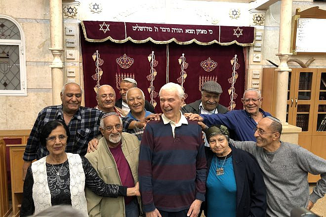 Capt. Elgen Long is embraced by Yemenite Jews during a visit to Israel last fall. Credit: Shahar Azani.