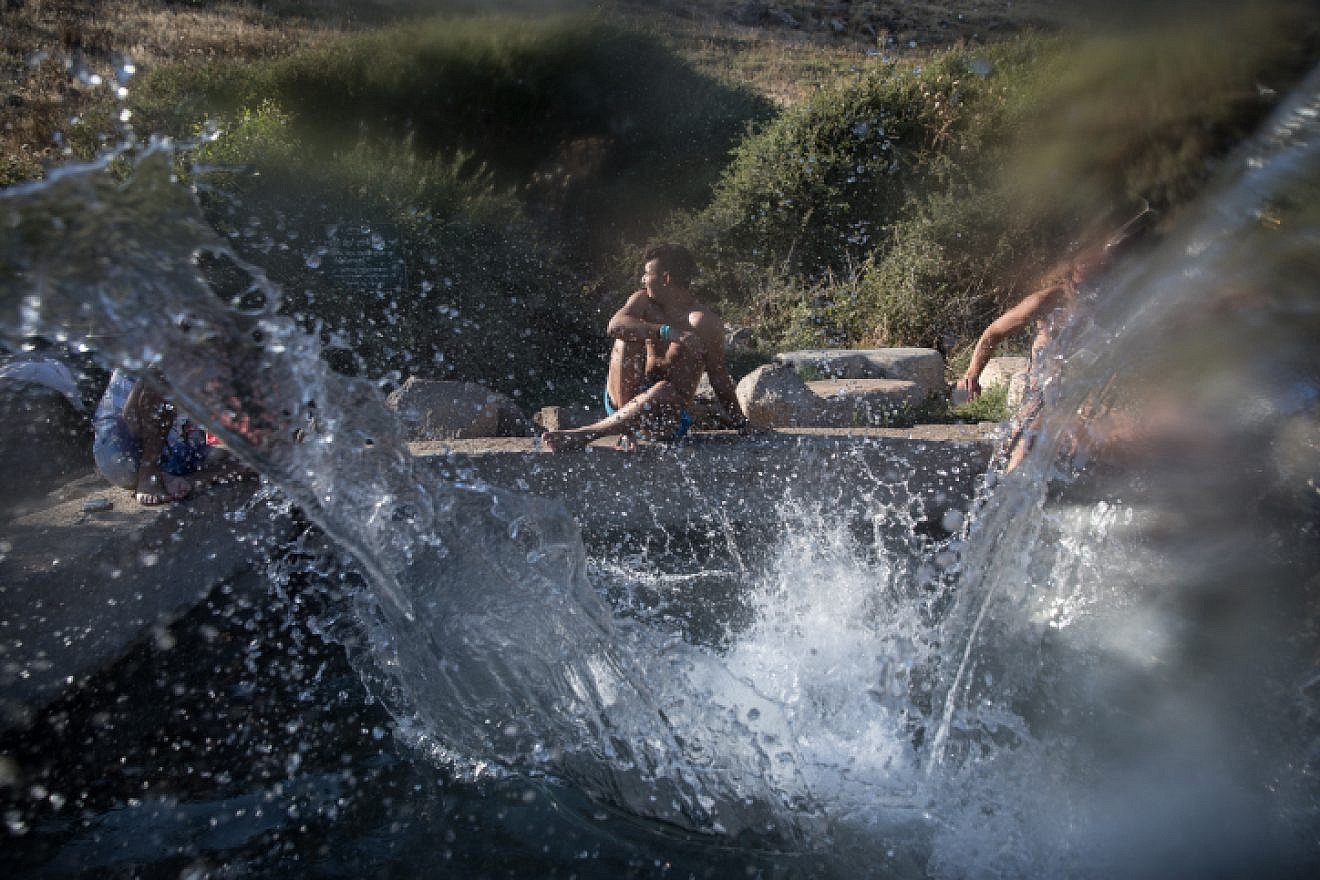Young Israelis enjoy the cool waters of the Ein Aya spring in the Golan Heights on July 29, 2018. Photo by Hadas Parush/Flash90.