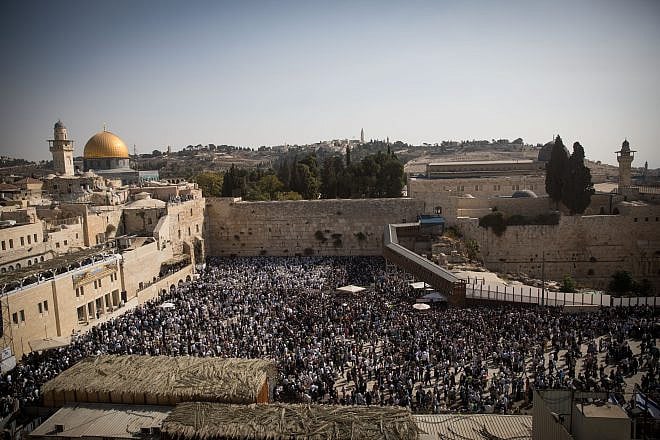 Jewish worshippers pray at the Western Wall in Jerusalem during the Cohen benediction priestly blessing during the holiday of Sukkot, Oct. 8, 2017. Photo by Yonatan Sindel/Flash90.