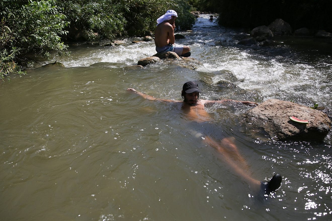Israelis cool off in a stream in the Golan Heights, although some remain off-limits for swimmers because of health reasons, Aug. 10, 2018. Photo by David Cohen/Flash90.