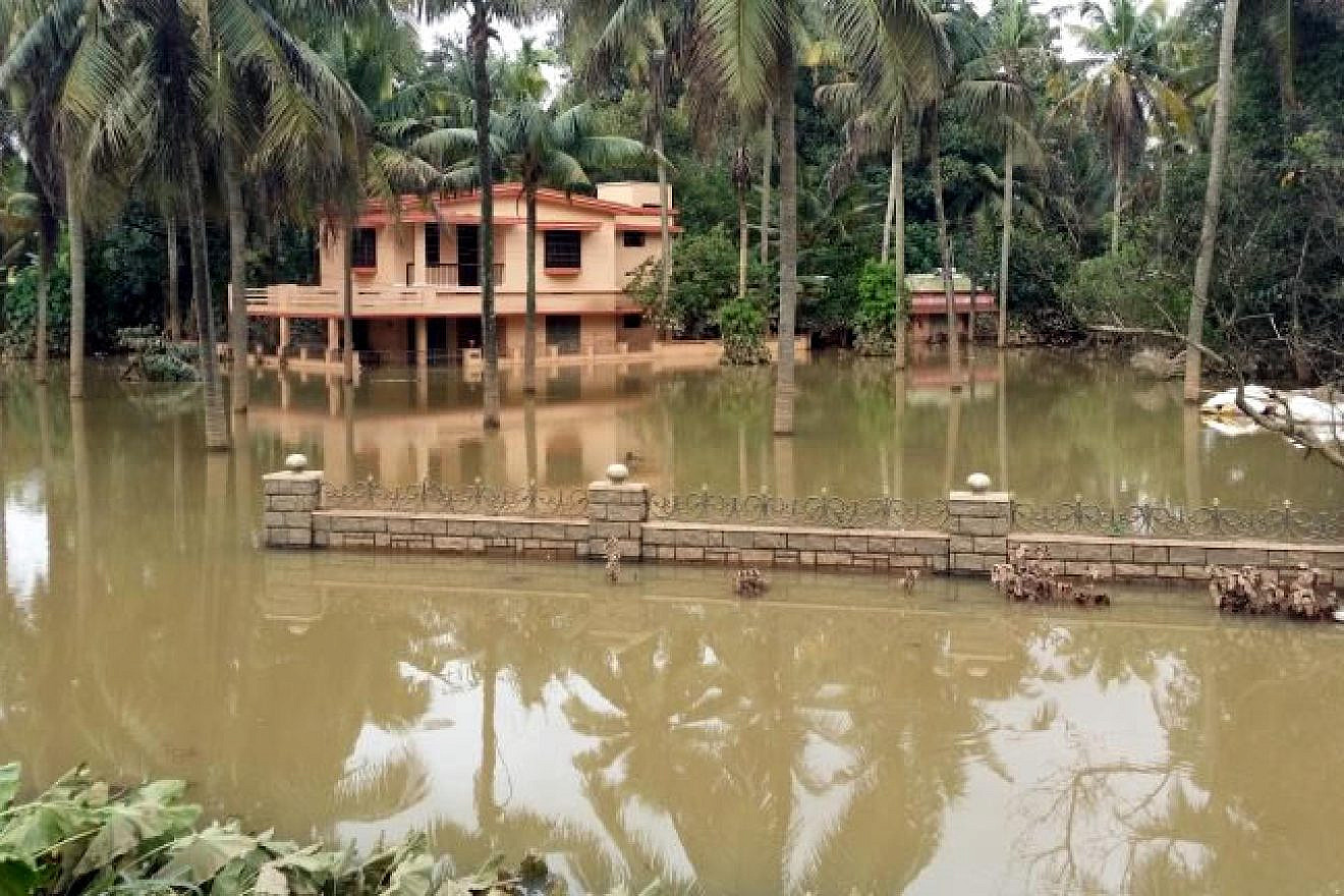 A flooded house in Kerala, India, in August 2018. Photo by Santhosh Varghese/Shutterstock.com.