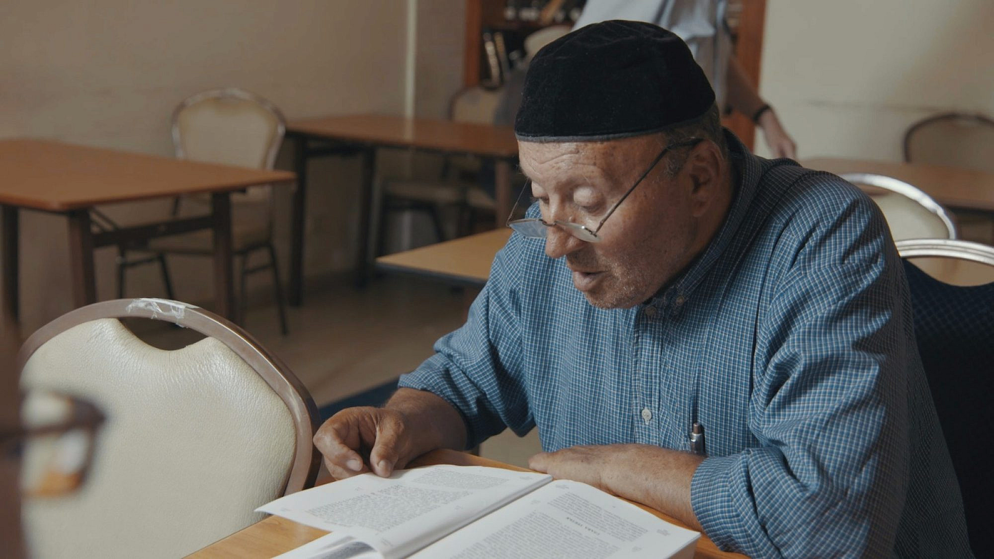 Many of the kollel participants never learned Torah before. Shown here is one active student pouring over a Bible. Credit: Courtesy.