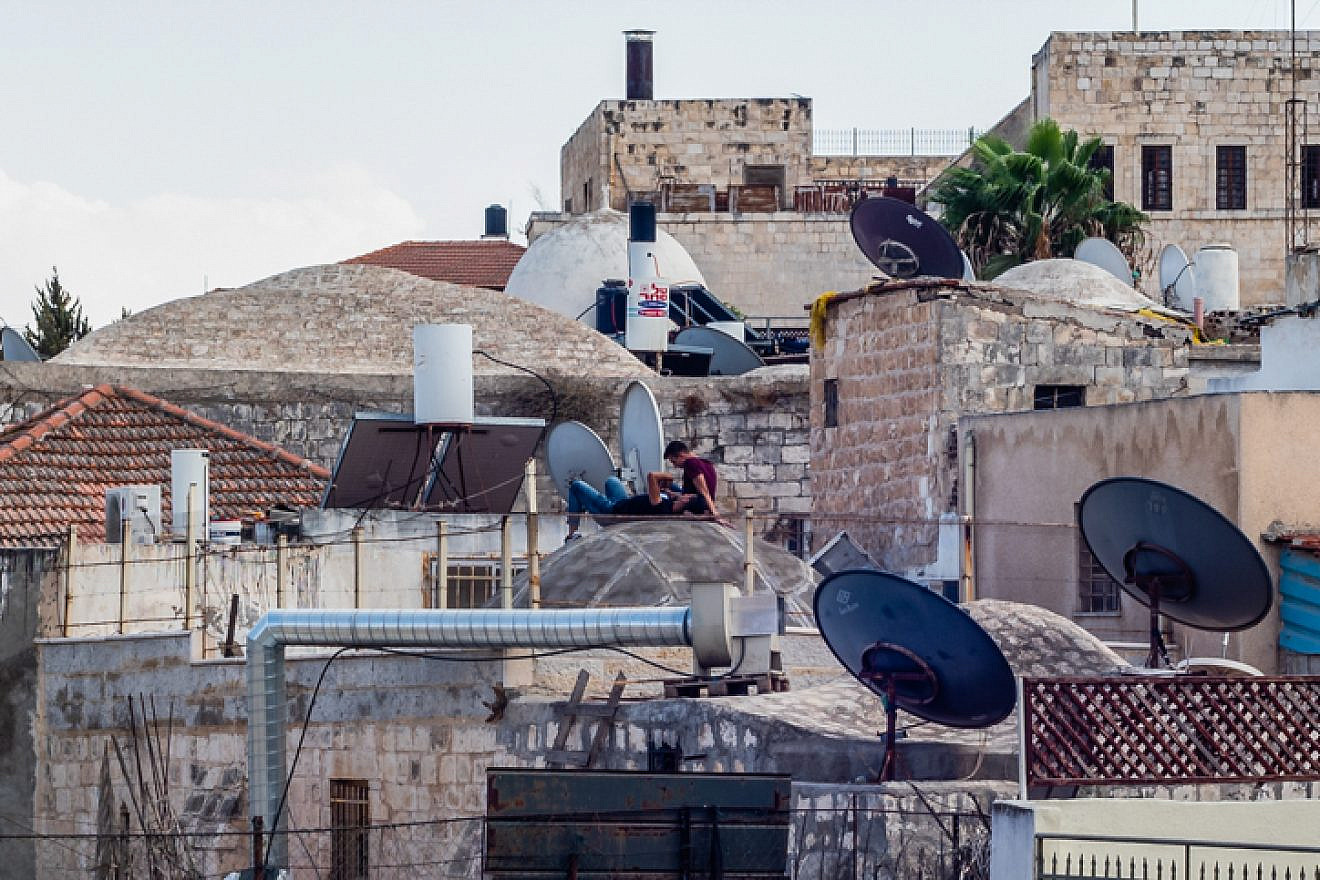 People rest on a rooftop in Jerusalem's Old City on Sept. 7, 2018. Photo by Dario Sanchez/Flash90.