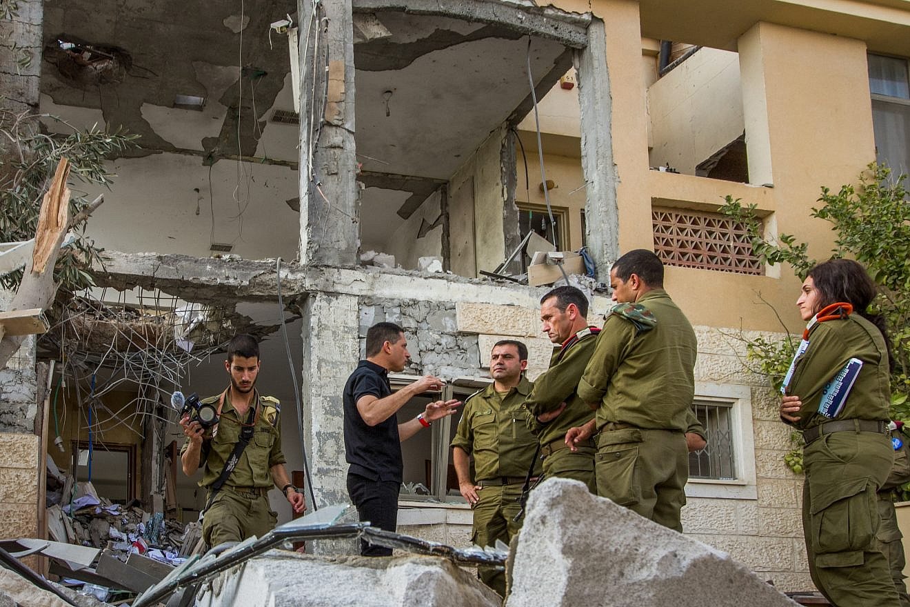 Maj.-Gen. Herzi Halevy (center), the chief of the Israeli Southern Command, visits the scene where a building was hit by a rocket fired by Hamas in Gaza in the southern Israeli city of Beersheva on Oct. 17, 2018. Photo by Flash90.