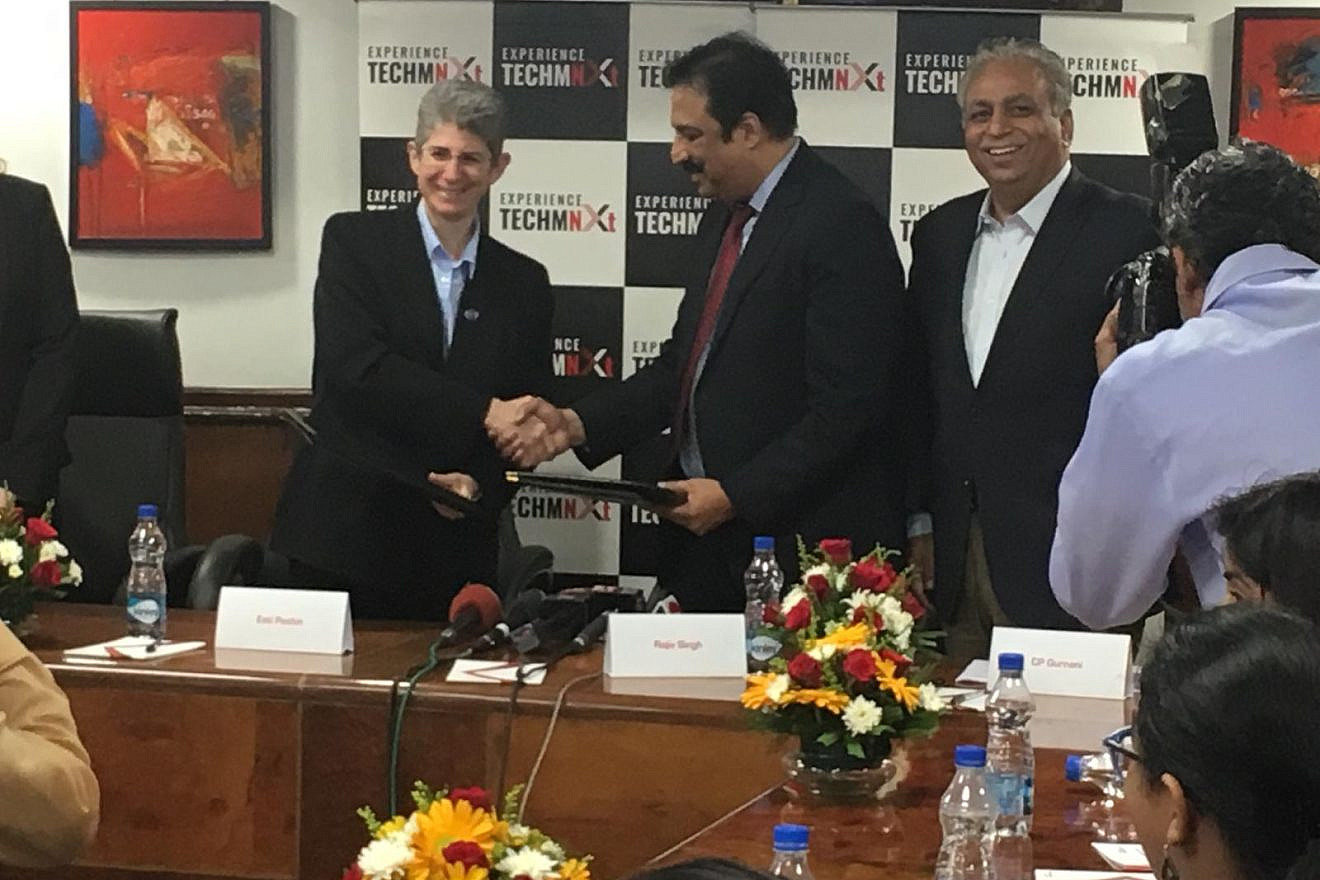 Esti Peshin, vice president and general manager of IAI’s Cyber Division, shakes hands with Rajiv Singh at a “Memorandum of Understanding” signing ceremony in New Delhi, India, on Oct. 3, 2018. Credit: IAI.