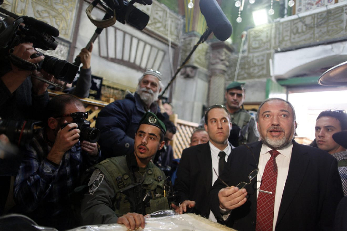 Israeli Defense Minister Avigdor Lieberman is seen surrounded by security as he visits the Tomb of the Patriarchs and Matriarchs in the city of Hebron on Jan. 14, 2013. Photo by Flash90.