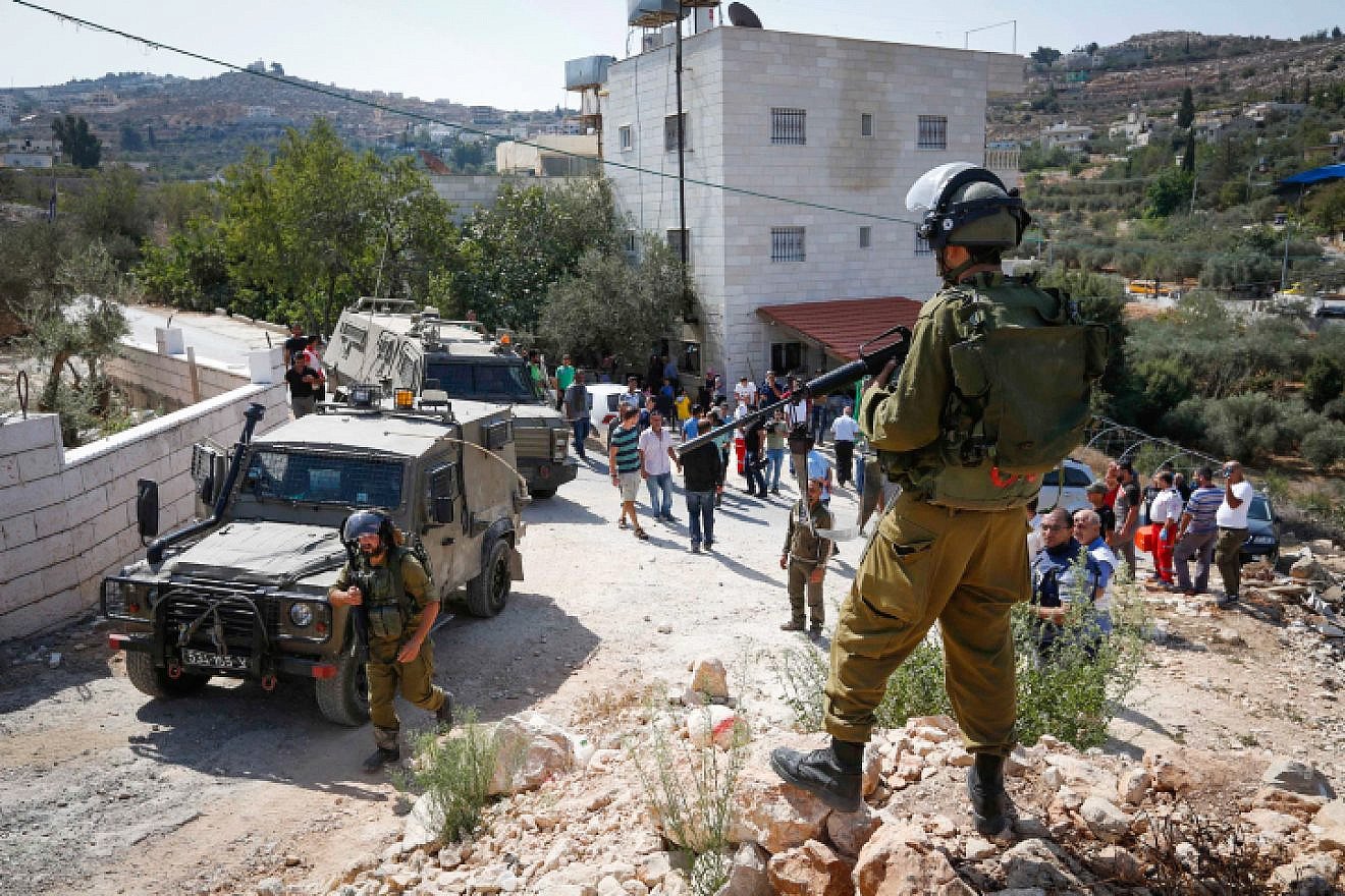 Palestinians clash with Israeli security forces as Israeli bulldozer demolishes a Palestinian house in the village of Walajeh, near Bethlehem on Sept. 3, 2018. Photo by Wisam Hashlamoun/Flash90.