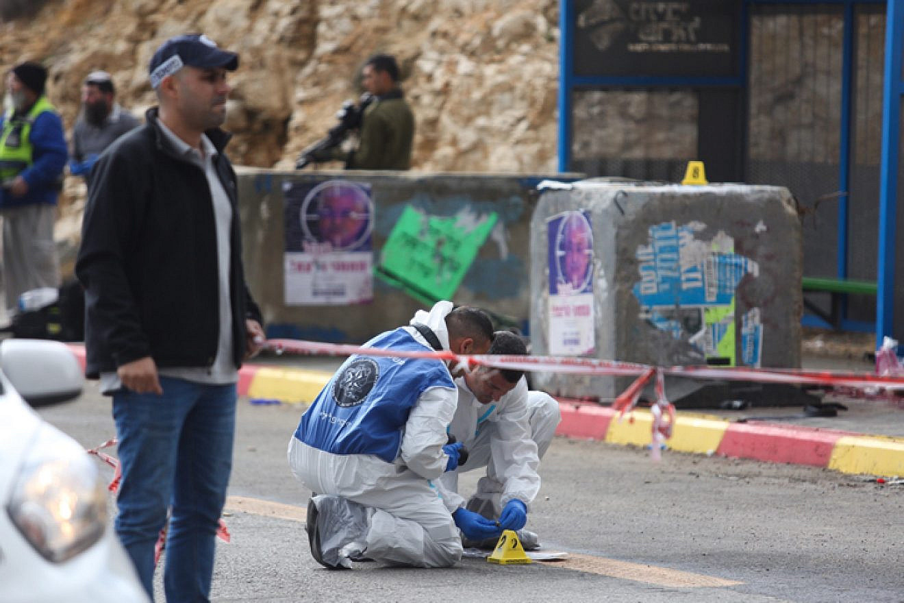 Israeli soldiers and police inspect the scene of a shooting attack at the entrance to the Israeli settlement of Givat Asaf, in the West Bank, on Dec. 13, 2018. Photo by Hadas Parush/Flash90.