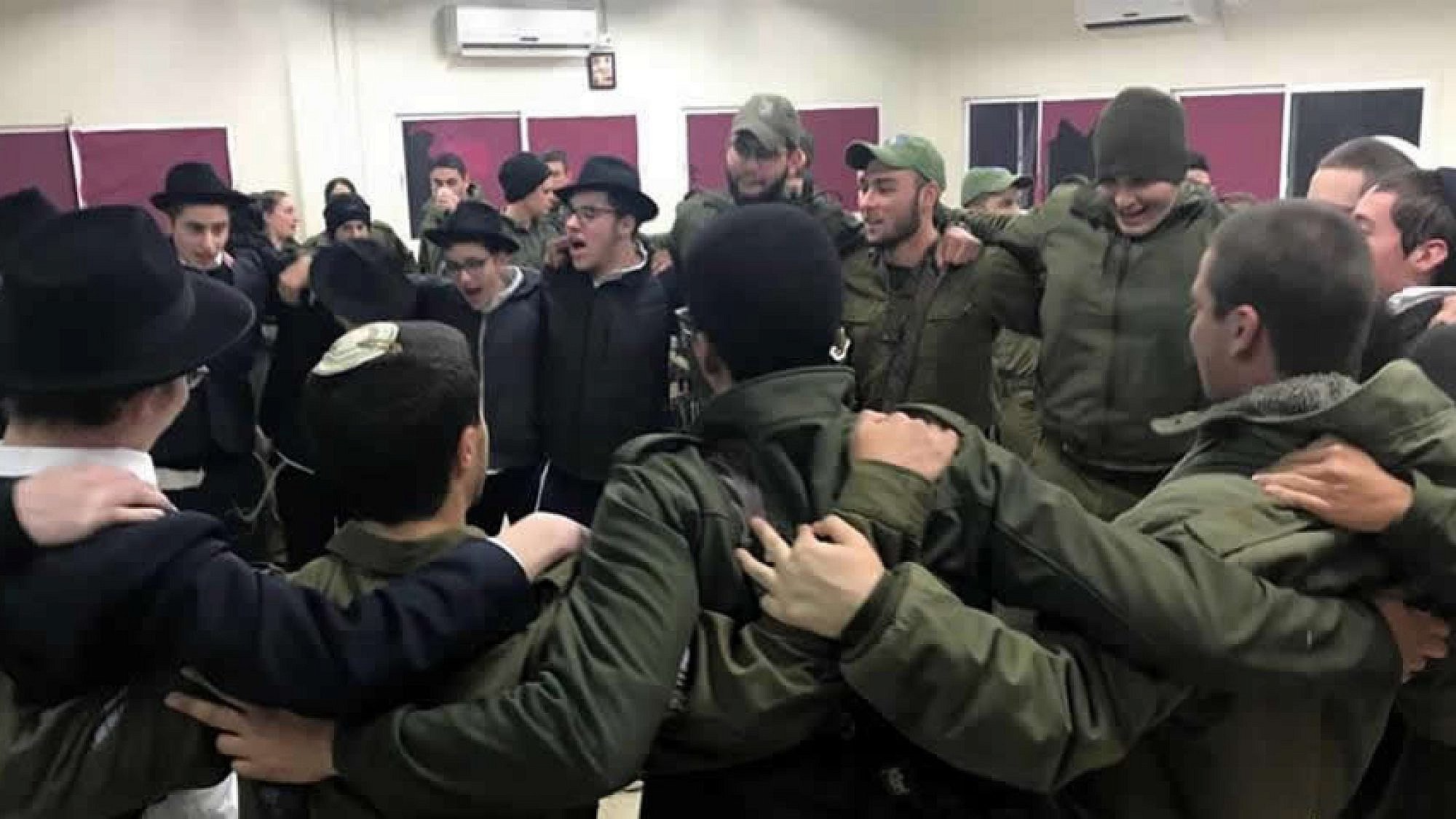 Yeshivah students from Tzfat dance with Israel Defense Forces troops in Metulla prior to an operation in which the troops destroyed a 40-meter-long-tunnel built by the Iranian-backed terror group Hezbollah. The tunnel started in the Lebanese town of Kfarkela and snaked its way into Metulla, an Israeli town of 1,000 surrounded on three sides by Lebanon. Credit: Chabad.org/News.
