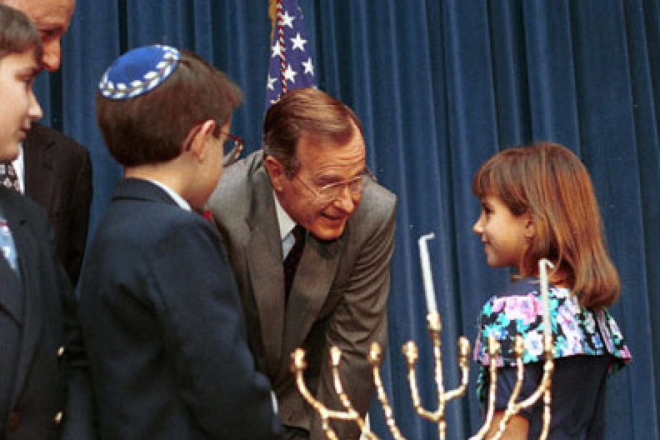 President George H. W. Bush speaks with children at 1991 White House Staff Hanukkah menorah-lighting. Credit: Archives and Records Administration.
