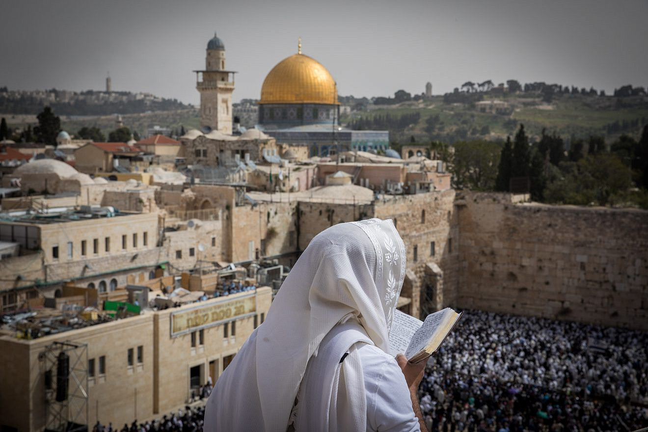 A man covers himself with a prayer shawl while praying near the Western Wall in Jerusalem's Old City, January 2019. Credit: Yonatan Sindel/Flash90.