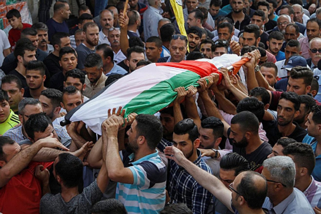 Palestinians carry the body of 48-year-old mother of eight Aisha Rabi, who died of her wounds after the car she was traveling in with her husband was hit by stones, during her funeral in the West Bank village of Bidya on Oct. 13, 2018. Credit: Nasser Ishtayeh/Flash90.
