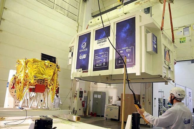 The first Israeli lunar spacecraft (covered, at left), named “Beresheet,” was loaded into a special shipping container on Jan. 17, 2019 in Israel to be flown to Florida ahead of SpaceIL’s historic mission to the moon on Feb. 21, 2019. Photo by Tomer Levi.