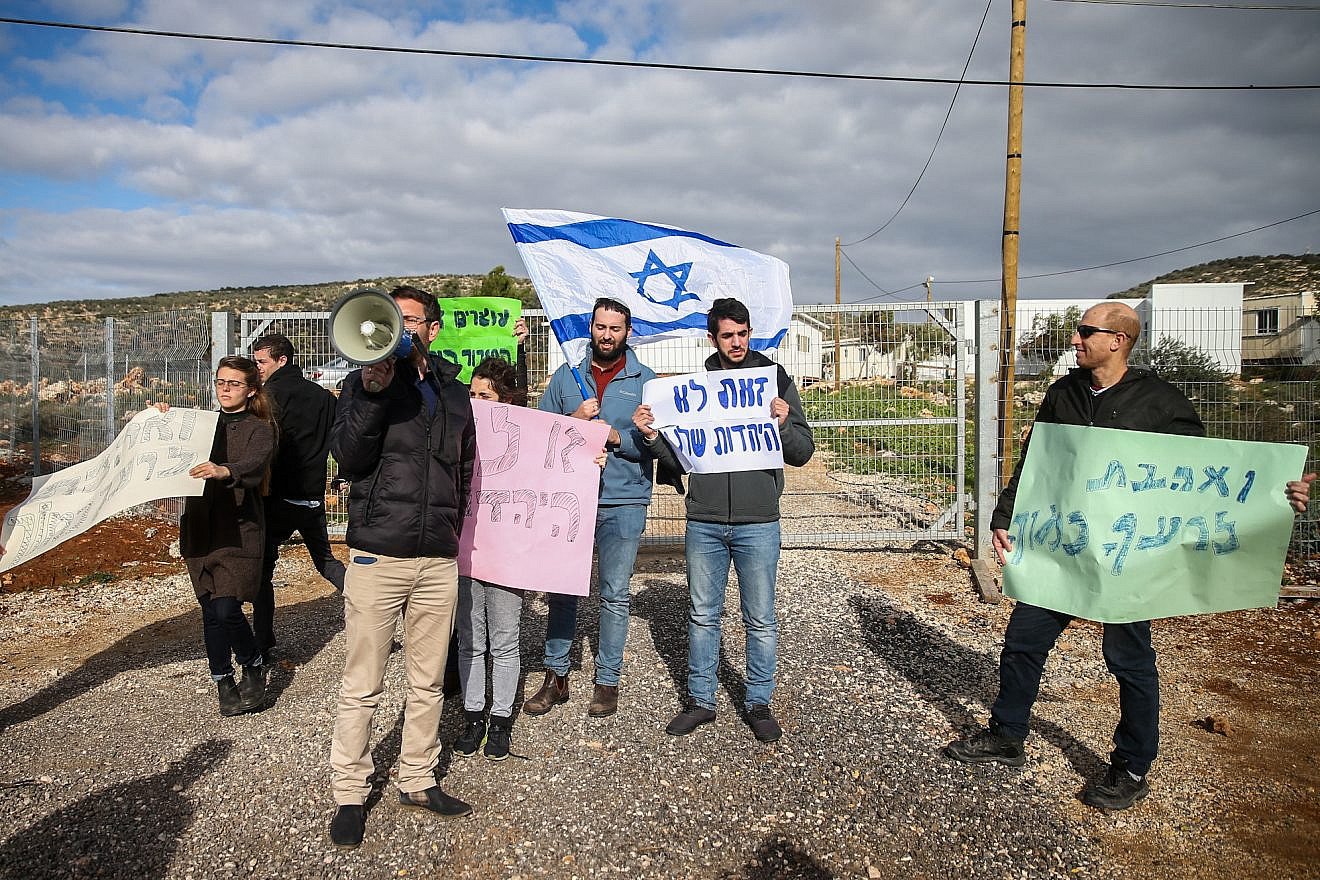 Israelis protest at the entrance to the Israeli settlement of Rehelim against the Jewish youth suspected in the killing of a Palestinian woman last year, Jan. 8, 2019. Photo by Ofer Meir/Flash90.