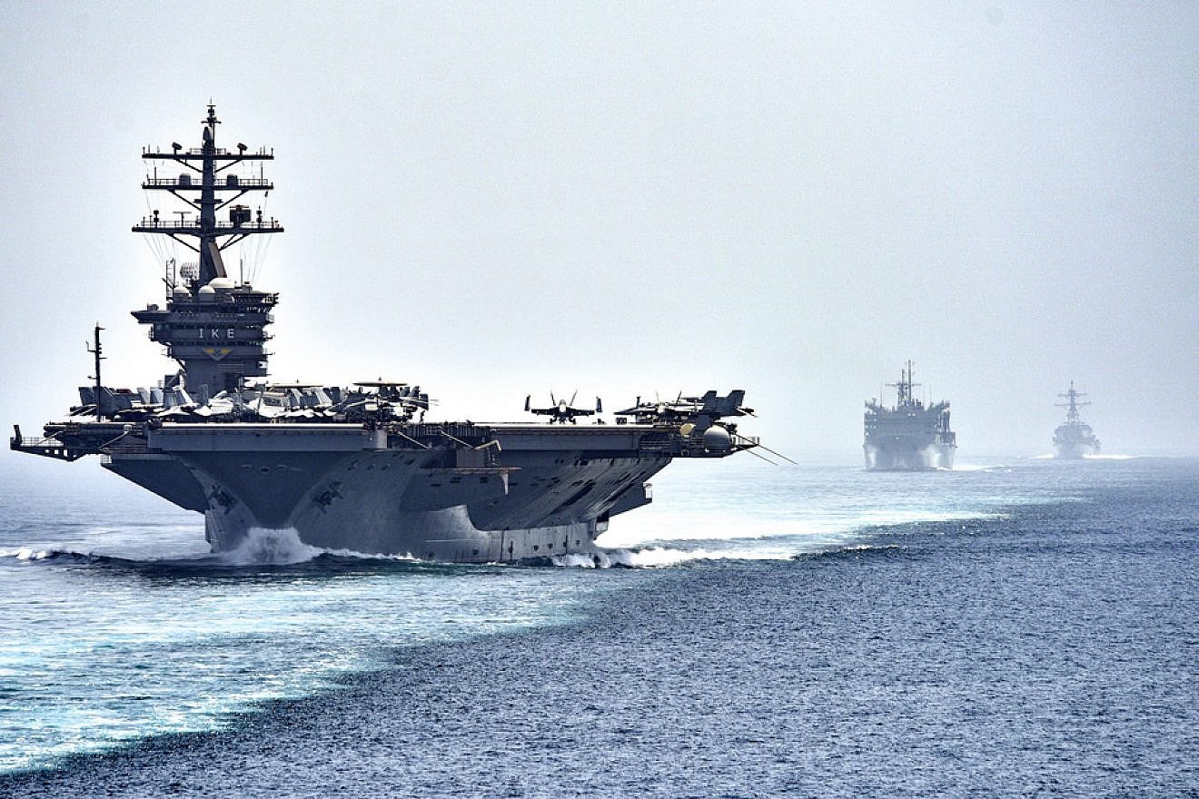 The aircraft carrier “USS Dwight D. Eisenhower," followed by the fast-combat support ship “USNS Arctic” and the guided-missile destroyer “USS Nitze,” transits the Strait of Hormuz. Photo by Mass Communication Specialist 3rd Class J. Alexander Delgado/U.S. Navy.