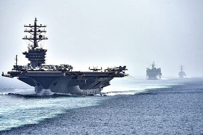 The aircraft carrier “USS Dwight D. Eisenhower," followed by the fast-combat support ship “USNS Arctic” and the guided-missile destroyer “USS Nitze,” transits the Strait of Hormuz. Photo by Mass Communication Specialist 3rd Class J. Alexander Delgado/U.S. Navy.
