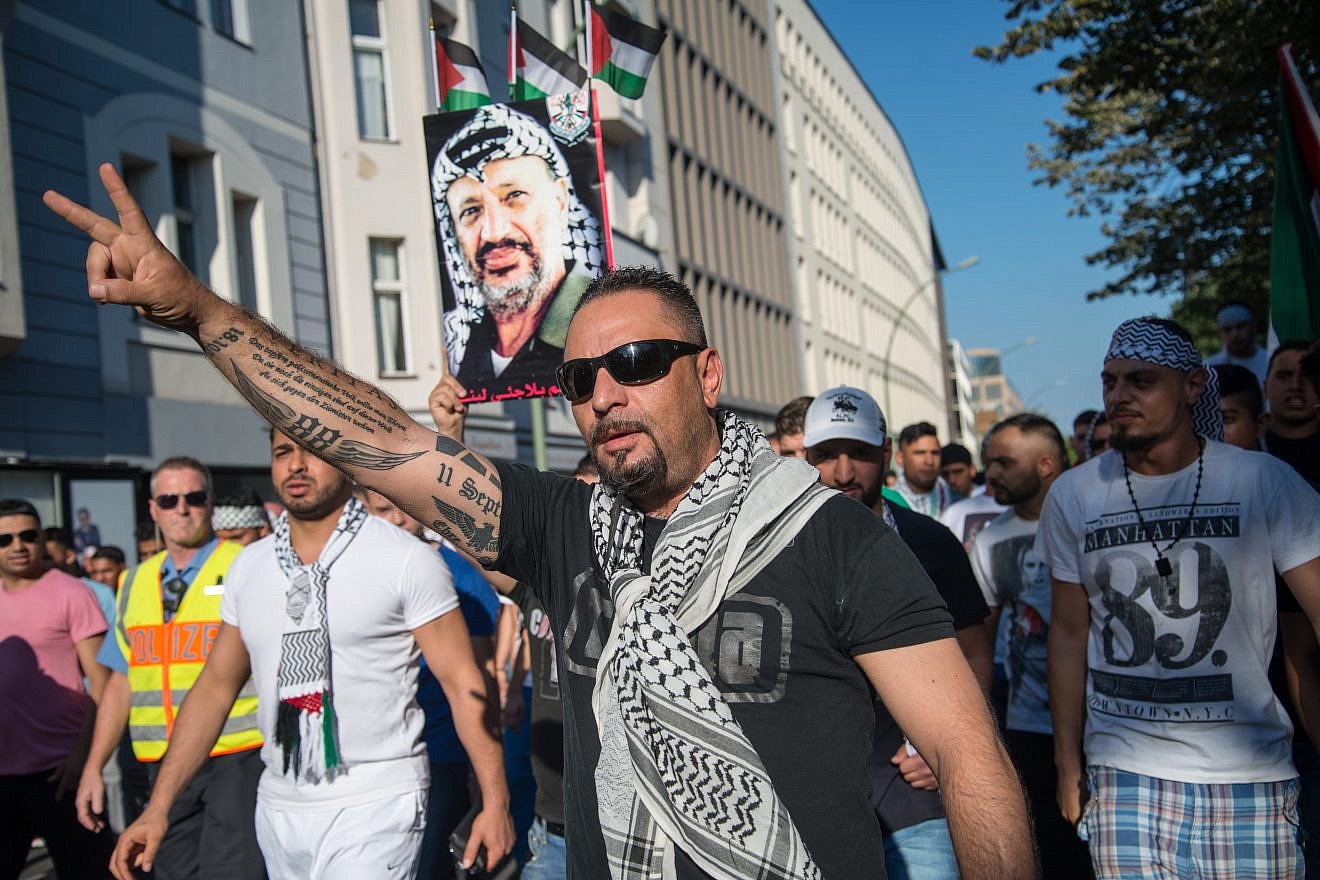 An antisemitic demonstrator in Berlin with Nazi tattoos on arm, July 17, 2014. Photo by Boris Niehaus via Wikimedia Commons.