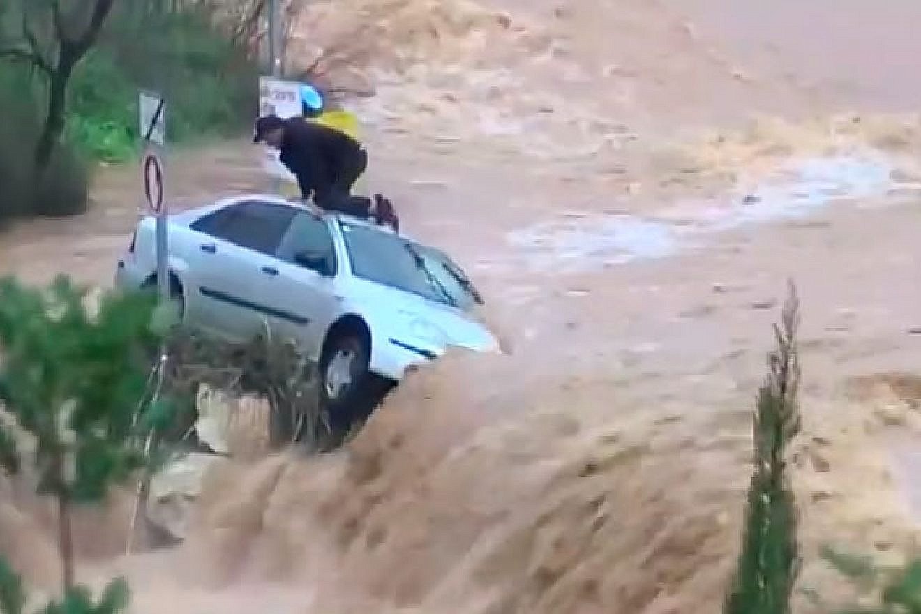 A man is trapped amid floodwaters in the Arazim Valley, west of Jerusalem, on Feb. 28, 2019. Credit: Screenshot.