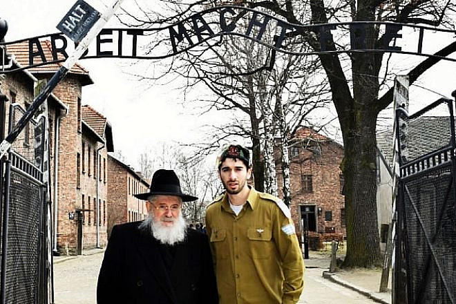 Holocaust survivor Rabbi Nissim Mangel and his grandson Leibel Mangel at Auschwitz. Credit: Leibel Mangel.