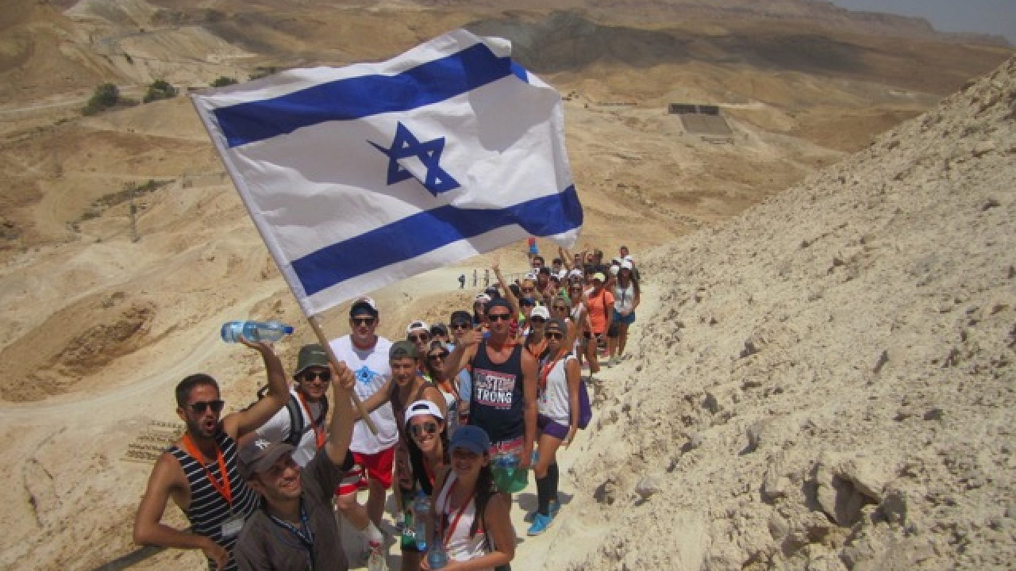 Birthright Israel participants hike up Masada. Credit: Courtesy.