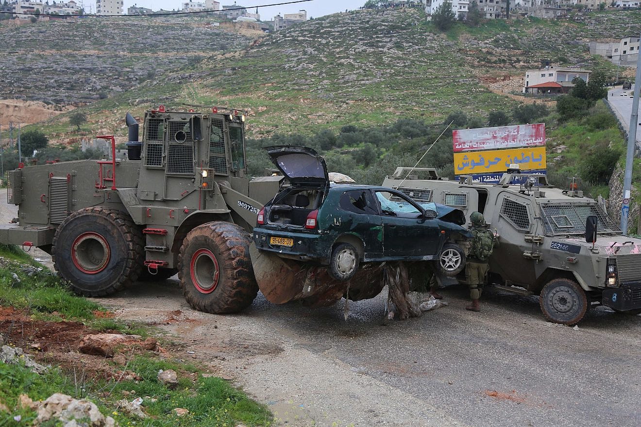 Israeli security forces at the scene where a Palestinian Arab driver ran over soldiers in Mateh Binyamin in the West Bank on March 4, 2019. Two IDF soldiers were wounded in the attack; the driver and his partner were killed. Photo by STR/Flash90.