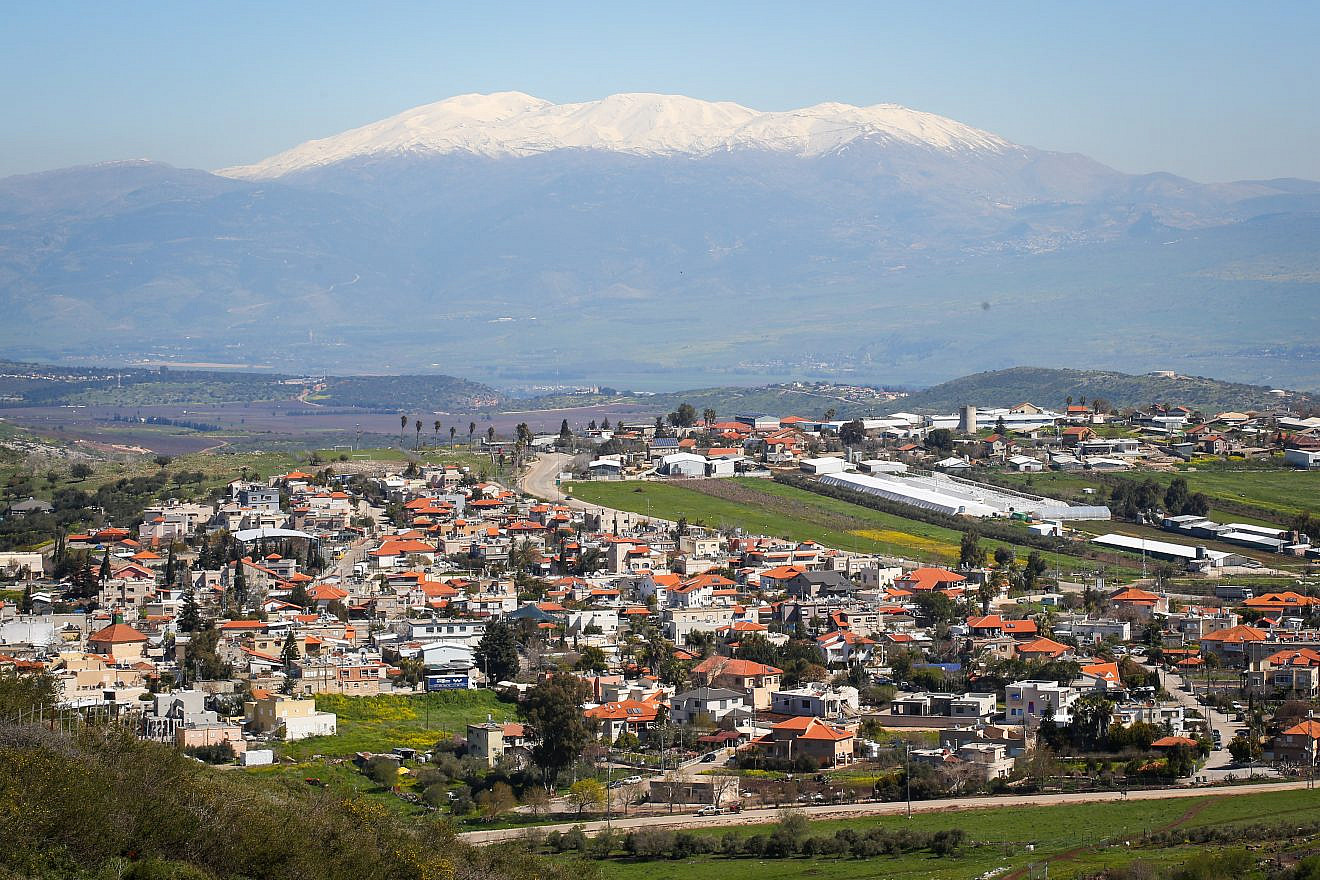 View of the Circassian village of Rehaniya, and Mount Hermon covered with snow in Northern Israel, as it seen from Route 886, on March 8, 2019. Credit: Yaakov Lederman/Flash90
