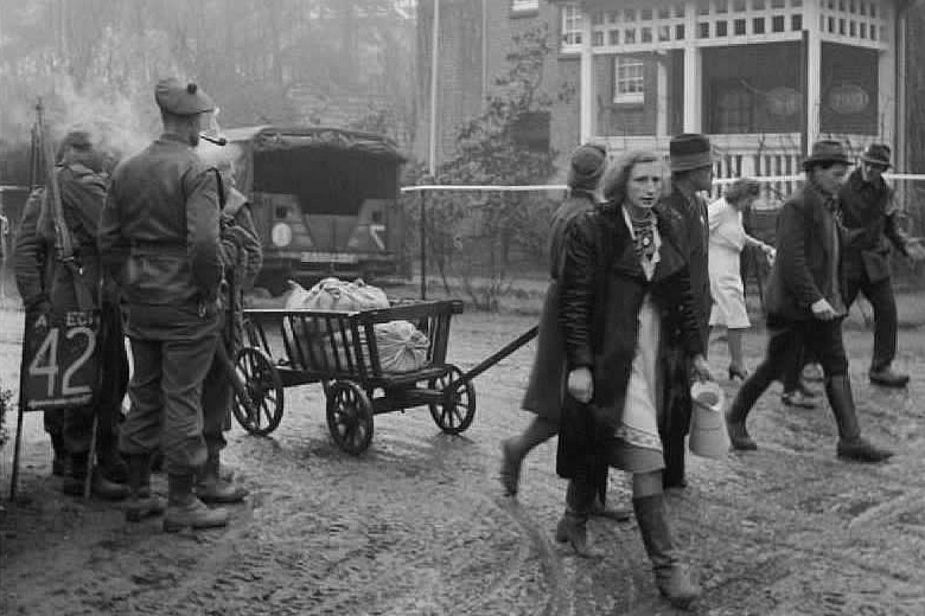 Scottish troops watch as German refugees stream back through the village of Bedburg near Kleve, Feb. 19, 1945. Credit: Imperial War Museum, London, part of the War Office Second World War Official Collection.