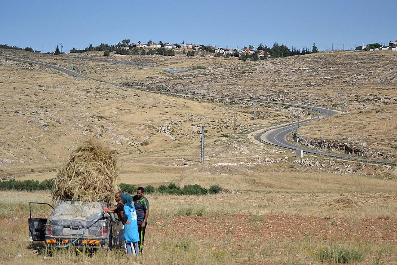 A family harvests crops in the South Hebron Hills, May 18, 2016. Photo by Eoghan Rice/Trócaire via Wikimedia Commons.