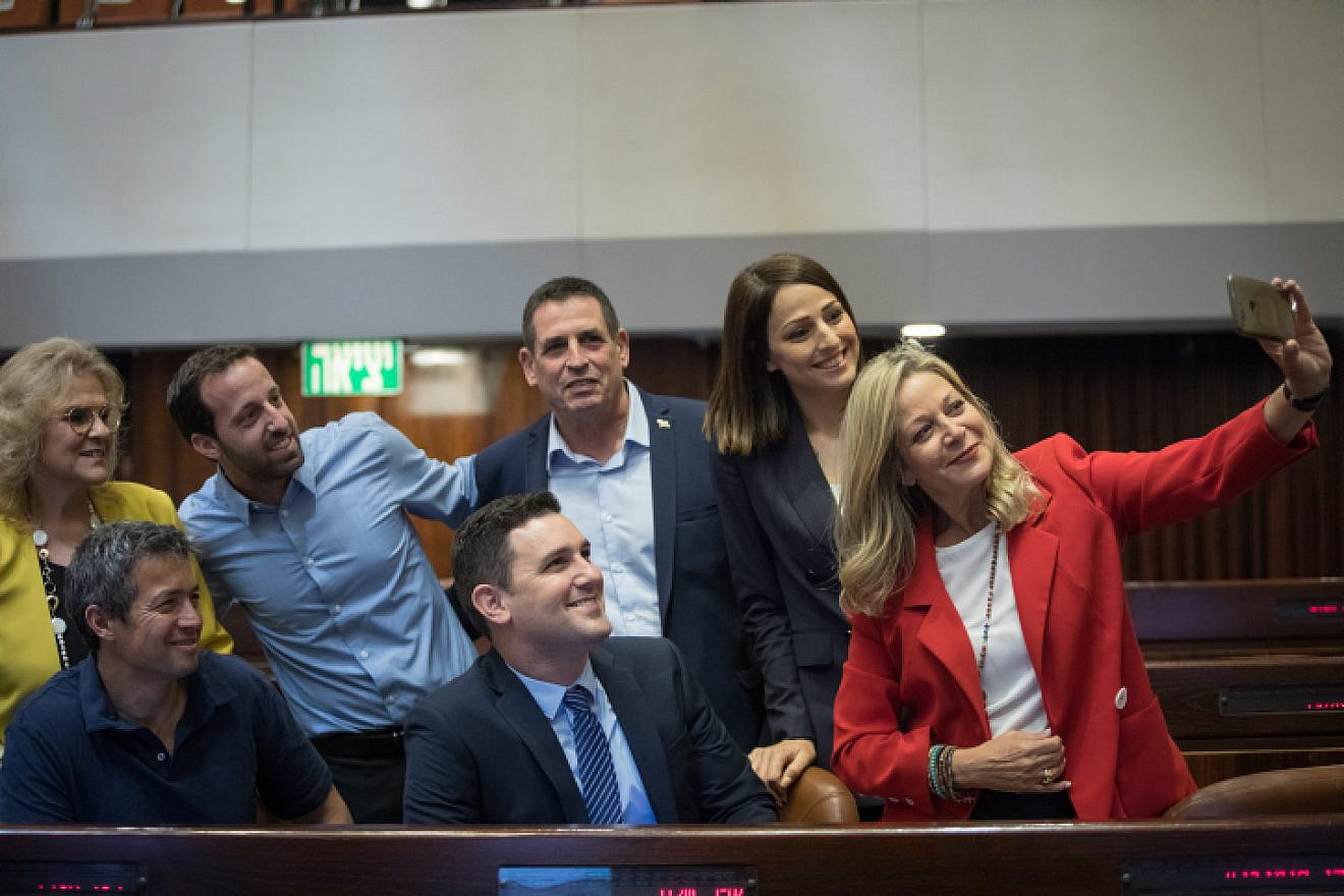New Knesset members Yoaz Hendel (bottom left), Yorai Lahav-Hertzano, Miki Haimovich (bottom right), Yehiel Tropper and Zvi Hauser are part of a selfie taken at the Knesset Plenary Hall ahead of the opening session of the new government, on April 29, 2019. Photo: Noam Revkin Fenton/Flash90.