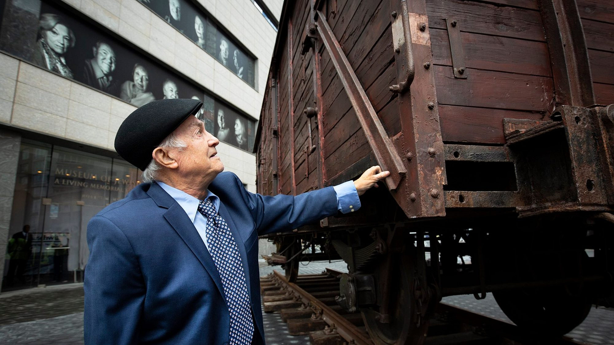 A man inspects a restored World War II-era German freight car as part of the Museum of Jewish Heritage's exhibit: “Auschwitz. Not long ago. Not far away.” Credit: Museum of Jewish Heritage via Facebook.