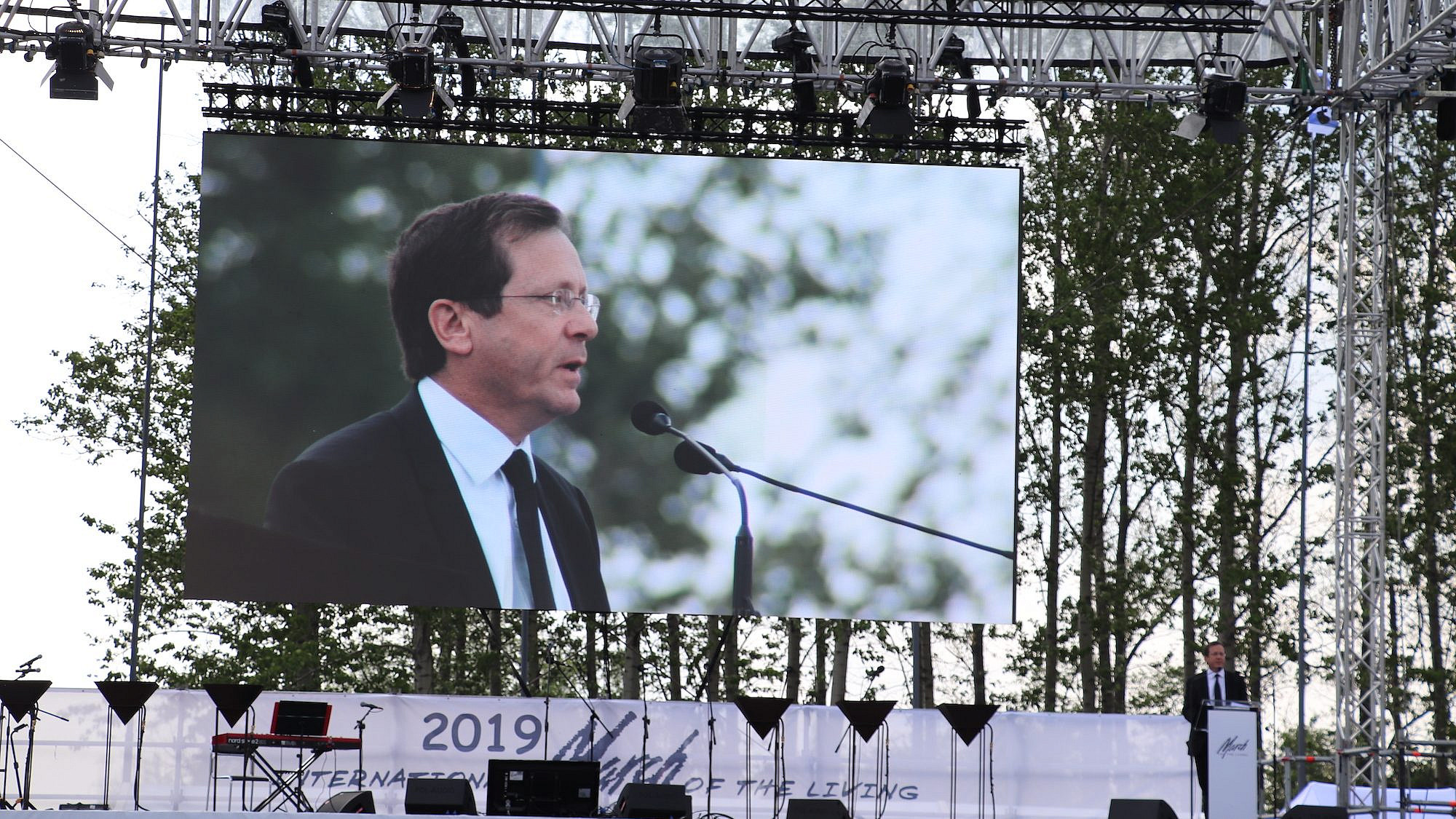 Then-Jewish Agency chairman Isaac Herzog speaks at the annual March of the Living program in Poland on May 2, 2019. Credit: Jewish Agency for Israel.