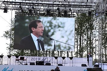 Then-Jewish Agency chairman Isaac Herzog speaks at the annual March of the Living program in Poland on May 2, 2019. Credit: Jewish Agency for Israel.