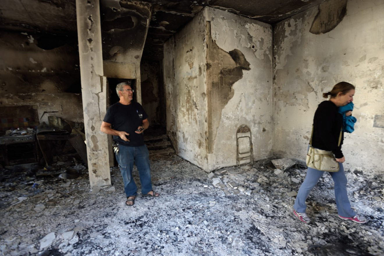 An Israeli woman reacts inside her burnt house, hit by a massive fire in the city of Haifa, Israel on November 25, 2016. Photo by Gili Yaari /Flash90.