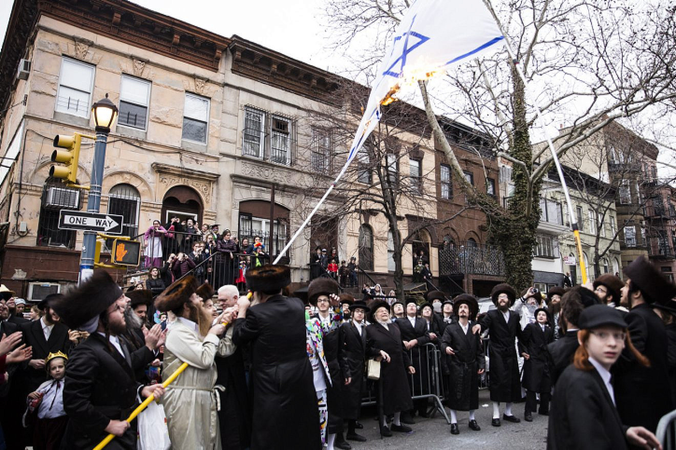 Haredi Jewish men burn an Israeli flag in the Williamsburg section of Brooklyn, N.Y., on March 1, 2018. Photo by Amir Levy/Flash90.