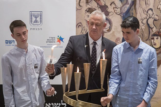 Blue and White Party chairman and Knesset member Benny Gantz lights a memorial candle with his sons during a Holocaust Remembrance Day ceremony at the Knesset in Jerusalem, May 2, 2019. Photo by Hadas Parush/Flash90.