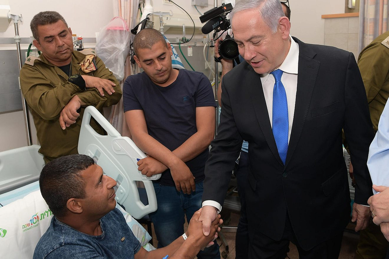 Israeli Prime Minister Benjamin Netanyahu visits IDF wounded soldiers at Soroka Medical Center in Beersheva. Credit: Amos Ben-Gershom/GPO.