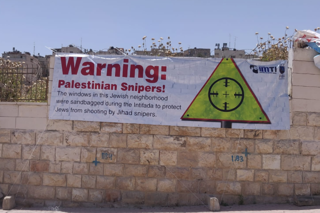 A poster in Hebron, created by the Jewish community of Hebron and the Im Tirtzu organization, to combat the narrative of Breaking the Silence, May 2019. Credit: Yishai Fleisher.