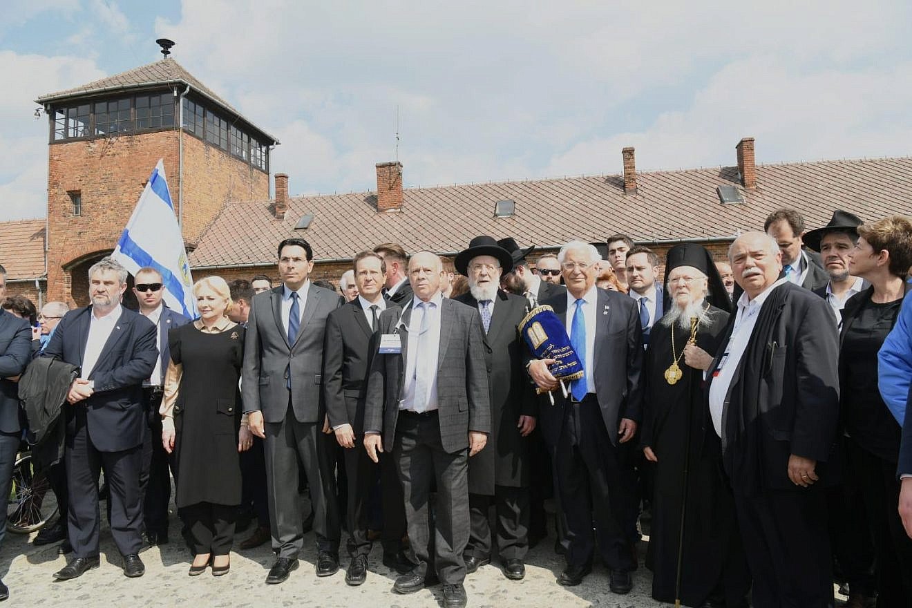 Dr. Shmuel Rosenman, founder and co-chairman of March of the Living, is flanked by Israel’s Ambassador to the United Nations Danny Danon; Jewish Agency chair Isaac Herzog; U.S. Ambassador to Israel David Friedman; and a delegation of U.S. ambassadors and White House representatives headed by Friedman, including former Israeli Chief Rabbi Israel Lau, and Ecumenical Patriarch Bartholomew I, Archbishop of Constantinople, at the entrance to Birkenau during the 31st annual March of the Living. Credit: March of the Living.