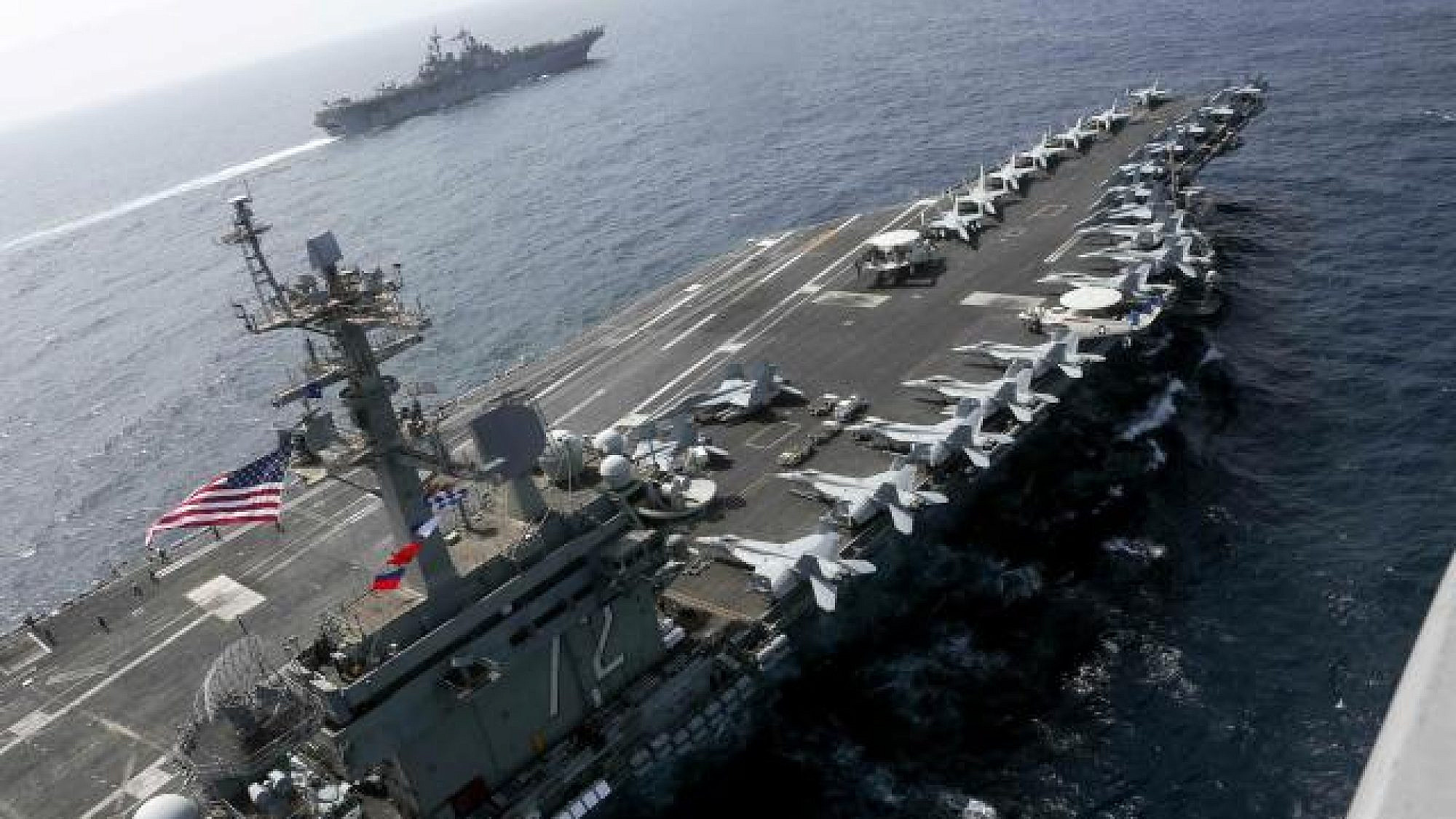 The “USS Abraham Lincoln” aircraft carrier sails in the Arabian Sea near the amphibious assault ship “USS Kearsarge,” equipped with vertical landing and takeoff aircraft and more than 1,600 Marines, May 15, 2019. Credit: U.S. Navy.