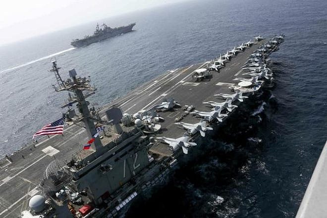 The “USS Abraham Lincoln” aircraft carrier sails in the Arabian Sea near the amphibious assault ship “USS Kearsarge,” equipped with vertical landing and takeoff aircraft and more than 1,600 Marines, May 15, 2019. Credit: U.S. Navy.