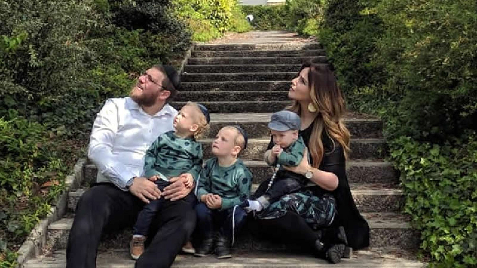 Rabbi Mordechai and Zlata Lewin, and their children, watch a military flyover in Normandy, France, site of the decisive Allied landing on D-Day that turned the tide of World War II. Credit: Chabad.org/News.