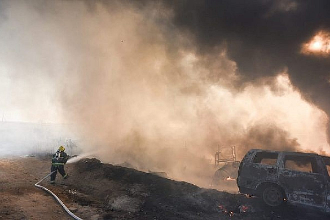 An Israeli firefighter works to extinguish a blaze caused by an incendiary device launched from the Gaza Strip into southern Israel on June 27, 2019. Credit: Israel Fire and Rescue Services.