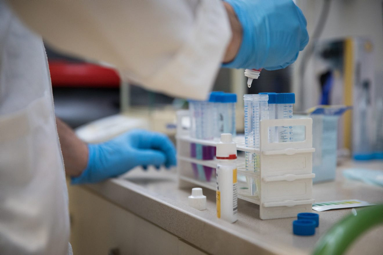 Illustrative: A researcher takes samples for testing at the Technion–Israel Institute of Technology in Haifa, on Feb. 19, 2019. Photo by Hadas Parush/Flash90.