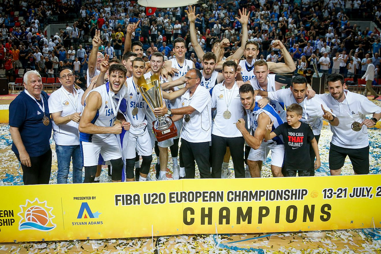 Players of the Israeli national under-20 basketball team celebrate with the trophy after beating Spain at the final of the FIBA U-20 Euro Championship in Tel Aviv on July 21, 2019. Photo by Roy Alima/Flash90.