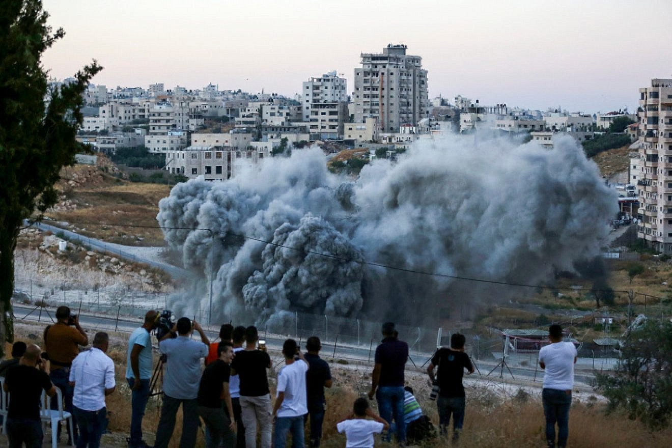 An illegally constructed building in Sur Baher along the security fence in eastern Jerusalem is blown up by Israeli forces on July 22, 2019. Photo by Wisam Hashlamoun/Flash90.