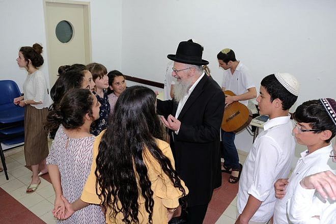 Tzfat Chief Rabbi Shmuel Eliyahu enjoys pre-Shabbat activities at the OneFamily Sleepaway camp in northern Israel in July 2019. Photo by Eytan Morgenstern.