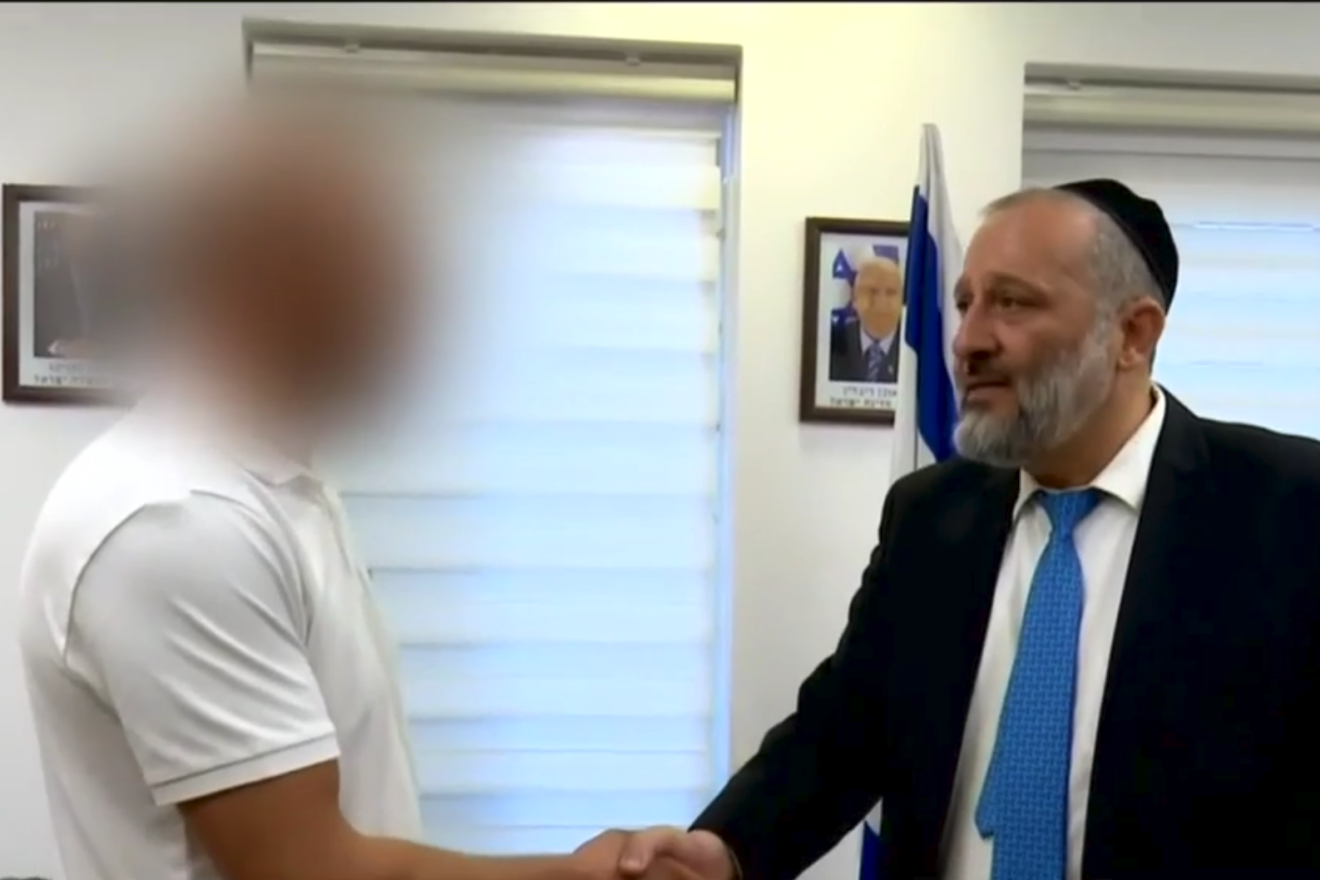 A Palestinian man who risked his life to save the wounded children of Rabbi Miki Mark, whose car was attacked near the Judean town of Otniel, is given Israeli residency by Interior Minister Arieh Deri, Aug. 6, 2019. Source: screenshot.