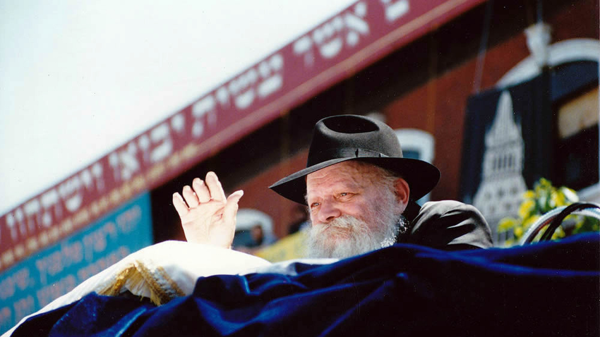 The Lubavitcher Rebbe, Rabbi Menachem Mendel Schneerson, waves to children at a Lag B'Omer parade in the Crown Heights neighborhood of Brooklyn, N.Y., on May 17, 1987. Credit: Mordecai Baron via Wikimedia Commons.
